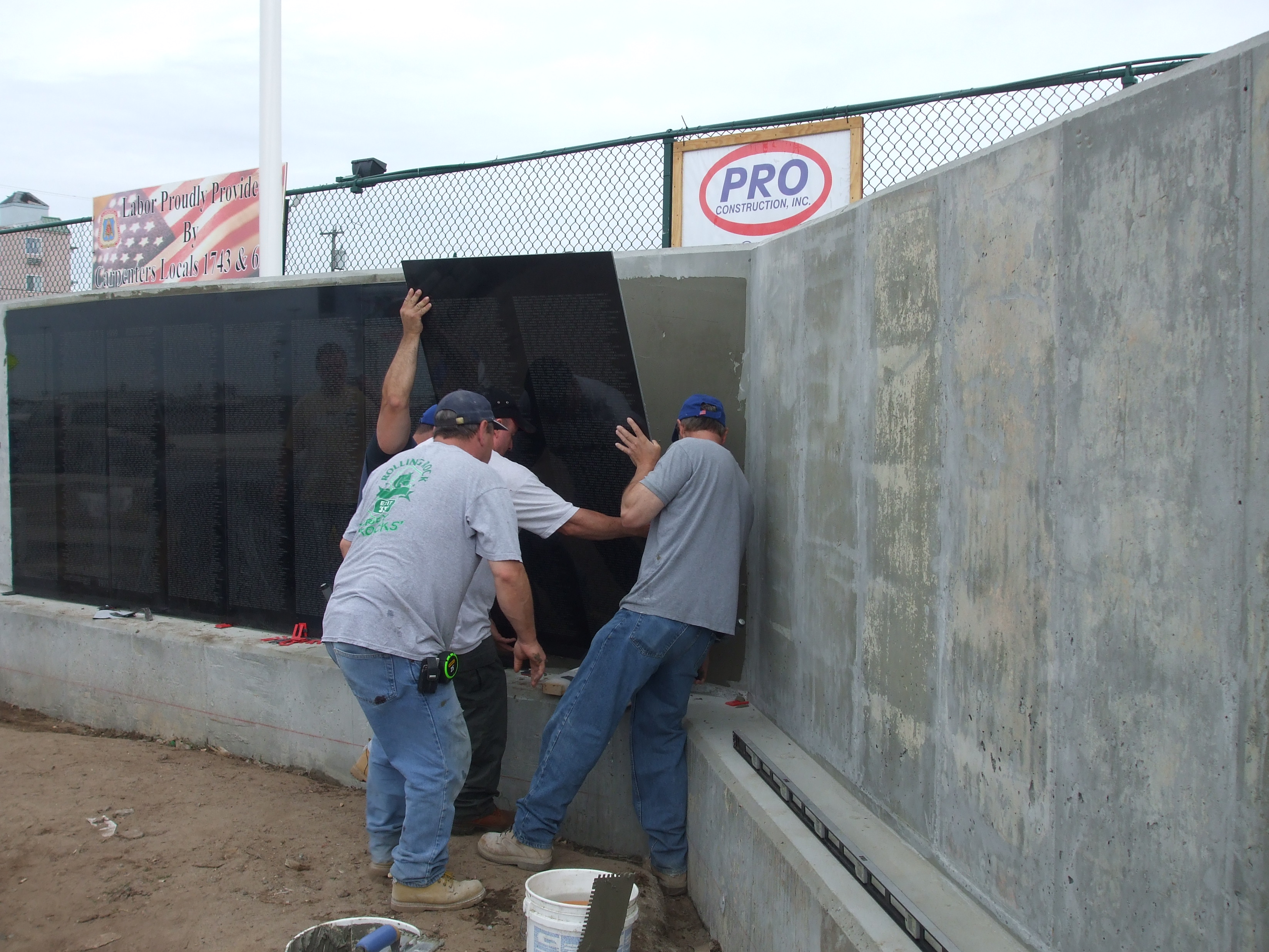 Crews erecting the wall